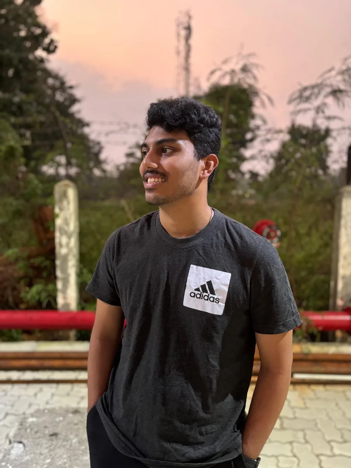 Ritesh smiling outdoors at sunset